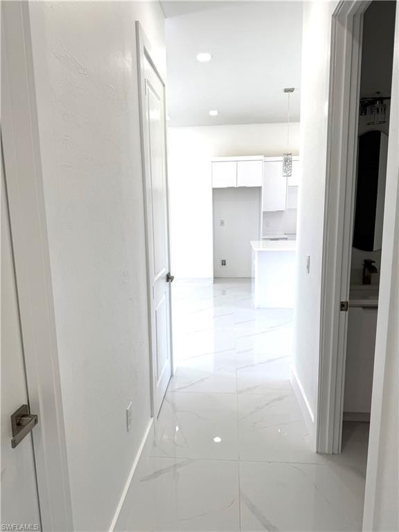 Bathroom with a marble finish shower, tile patterned flooring, and vanity