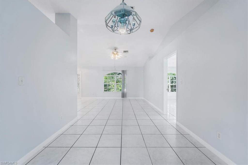 Unfurnished room with ceiling fan and light tile patterned flooring