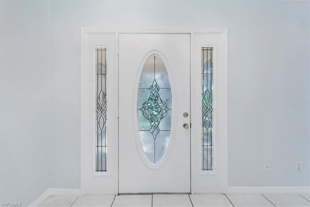 Unfurnished room featuring light tile patterned floors and a ceiling fan