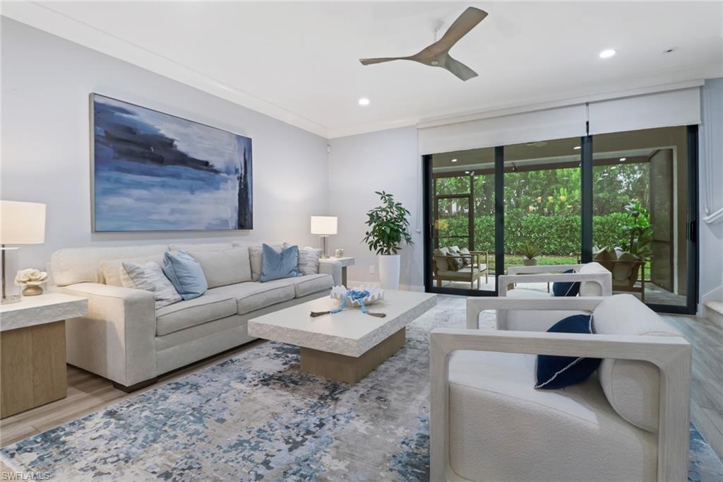 Living room featuring light wood-style floors, recessed lighting, ceiling fan, and ornamental molding