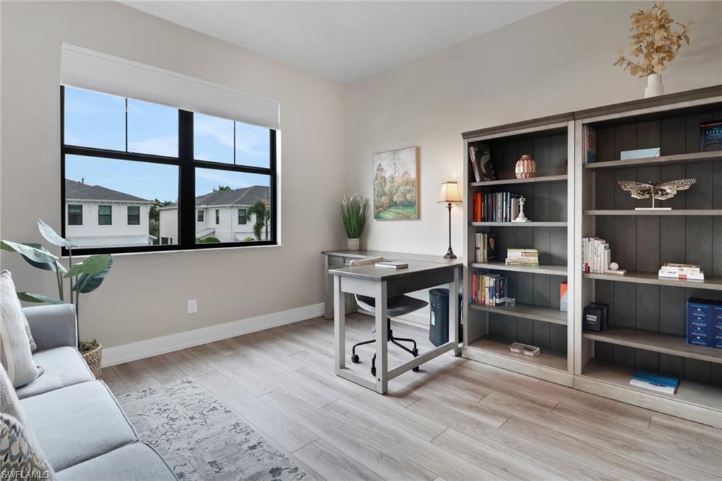 Office space featuring baseboards and light wood finished floors