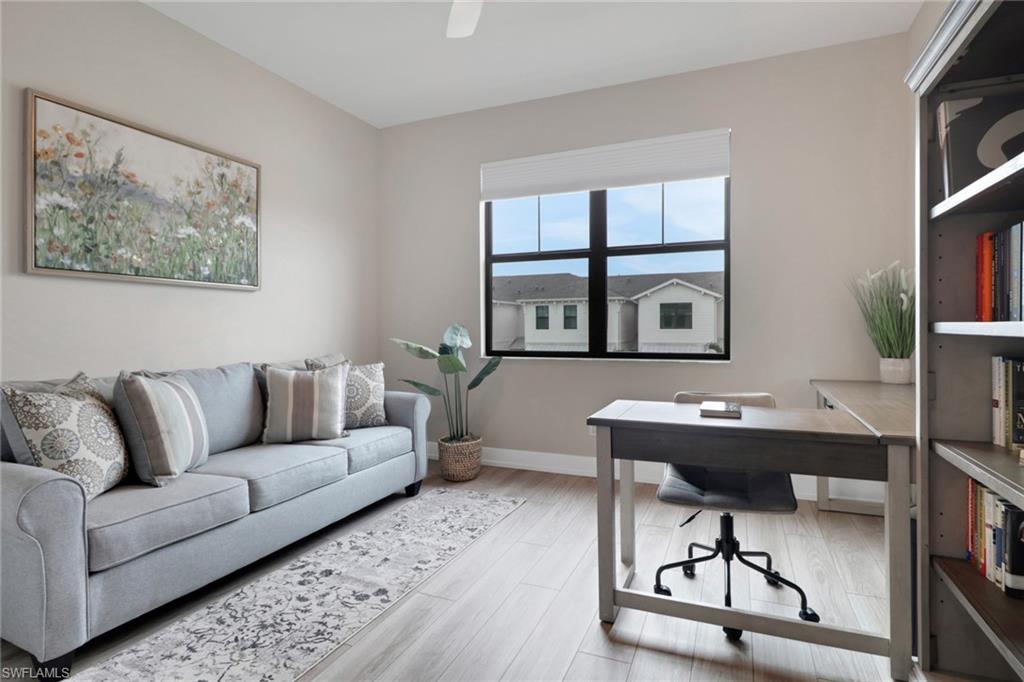 Home office with baseboards and light wood finished floors