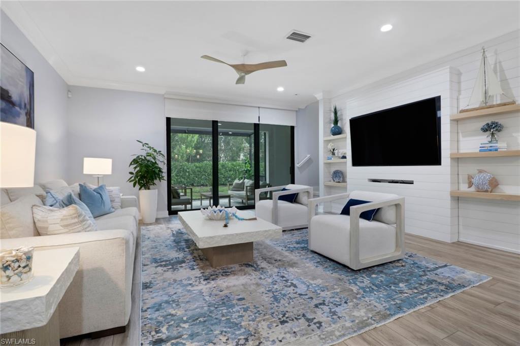 Living room featuring wood finished floors, recessed lighting, a ceiling fan, and ornamental molding