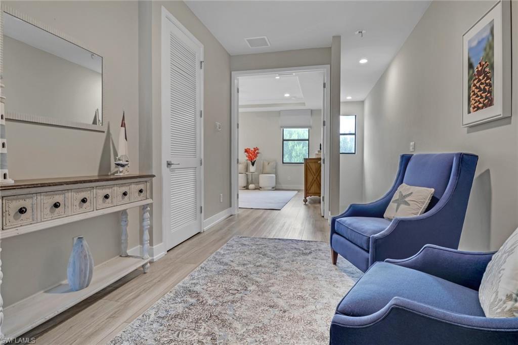 Living area featuring light wood-type flooring and recessed lighting