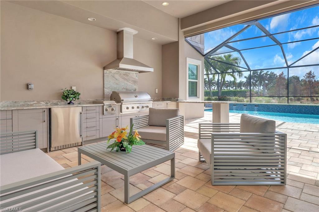 View of patio / terrace featuring a grill, area for grilling, and glass enclosure
