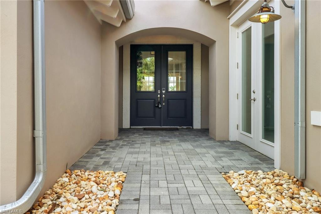 Property entrance featuring french doors