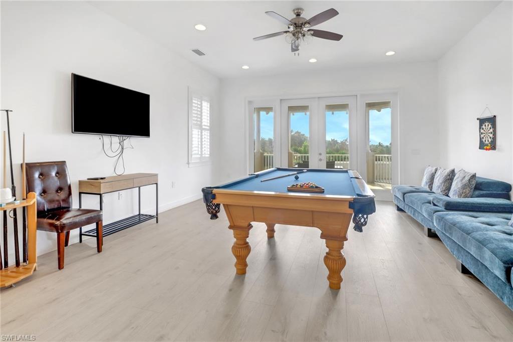 Playroom featuring french doors, light hardwood / wood-style flooring, pool table, and ceiling fan