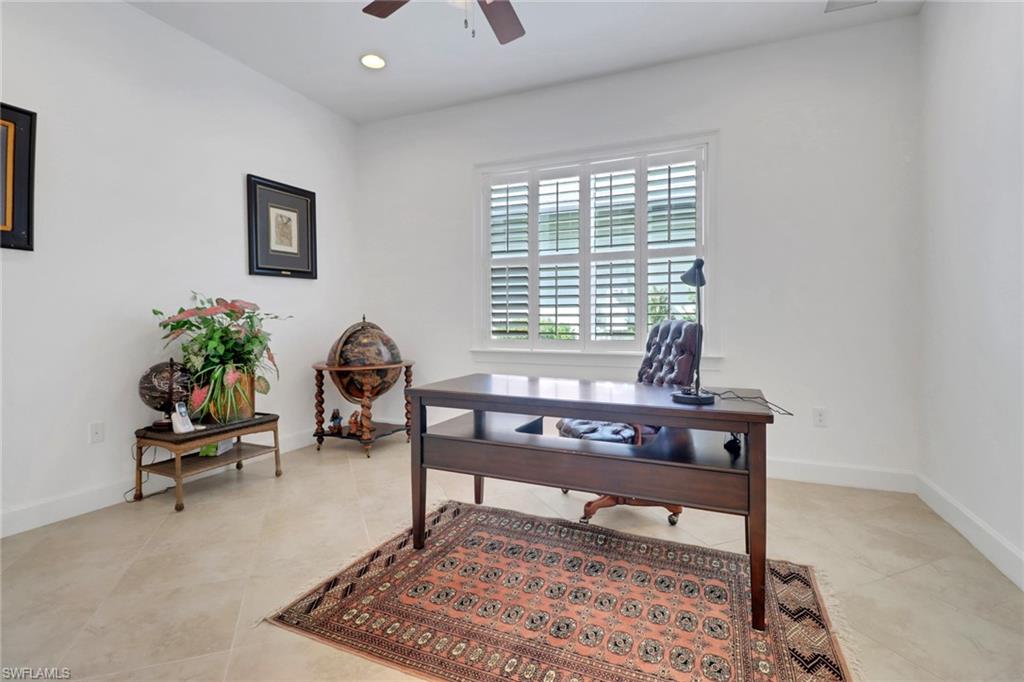 Office space with light tile patterned flooring and ceiling fan