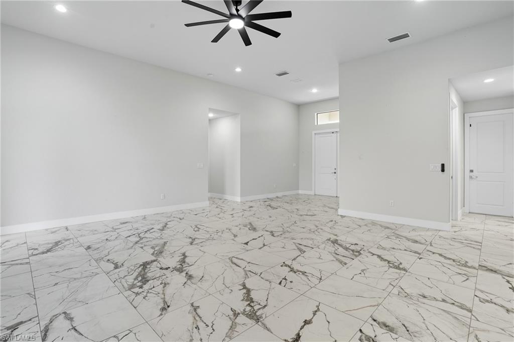 Empty room with light marble finish floors, recessed lighting, and a ceiling fan