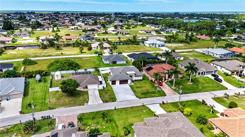 Aerial view of residential area featuring a large body of water