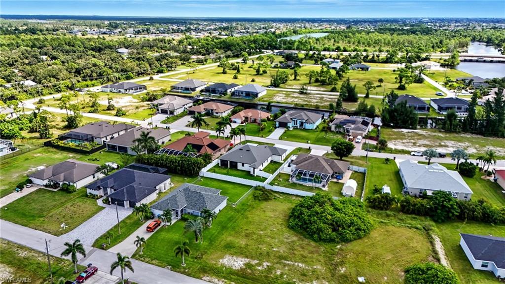 Aerial perspective of suburban area featuring a large body of water