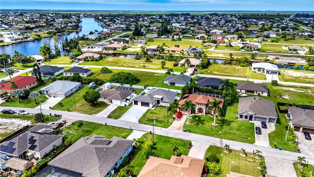 Aerial view of residential area featuring a large body of water