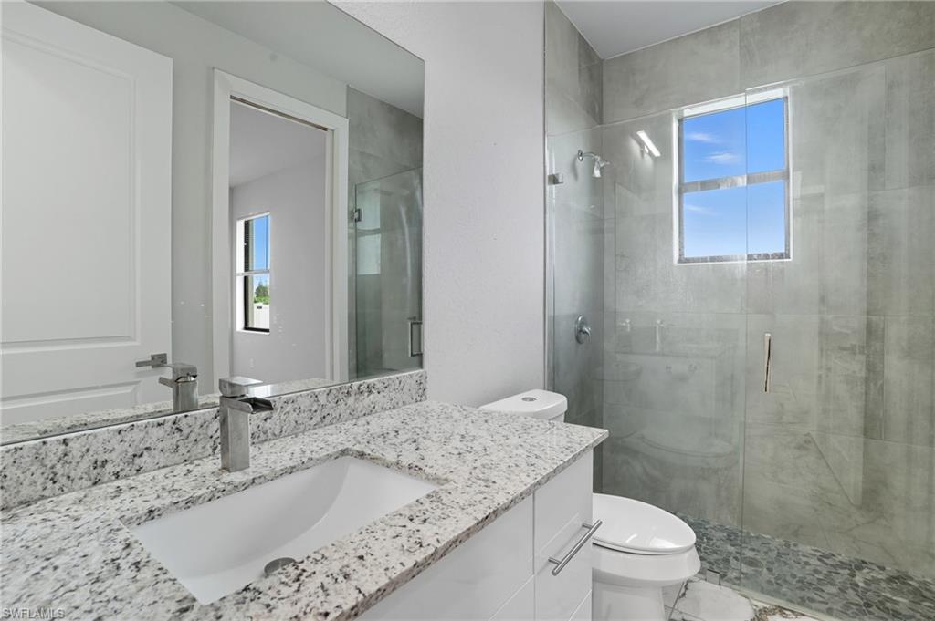 Full bath with a stall shower and vanity