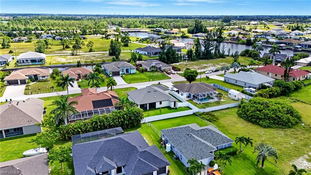 Aerial perspective of suburban area featuring a nearby body of water