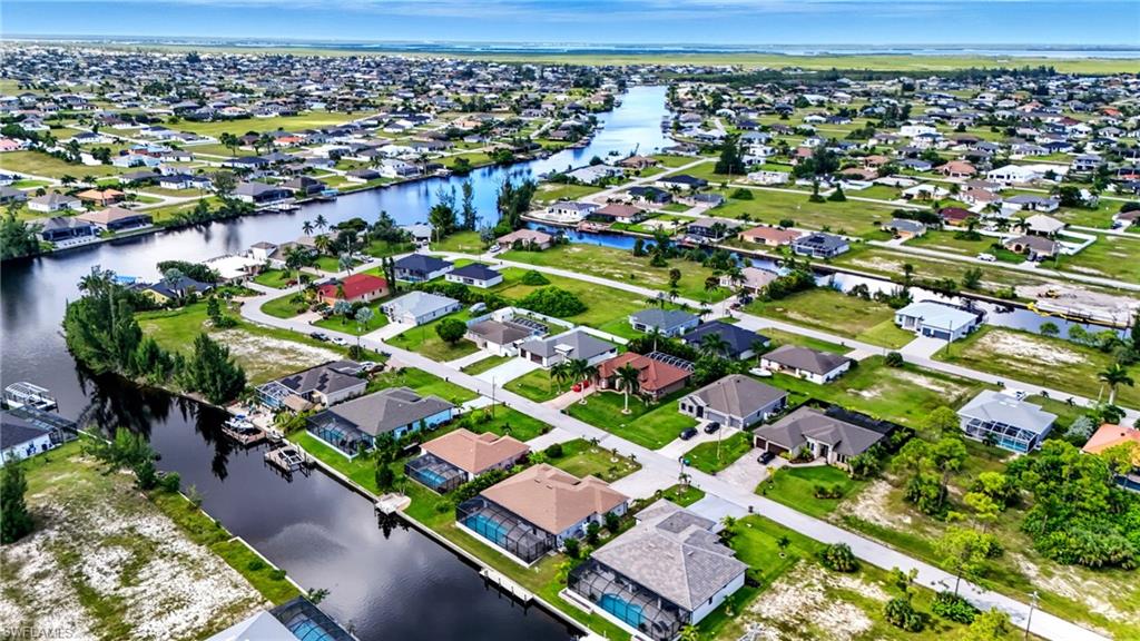 Aerial view of property's location with nearby suburban area and a nearby body of water