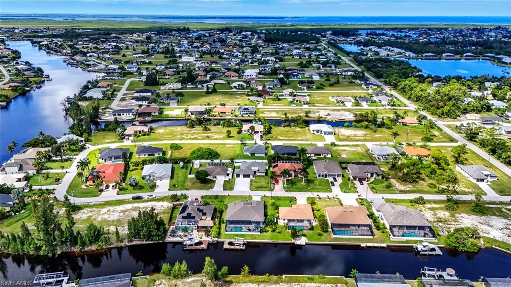 Aerial perspective of suburban area with a large body of water