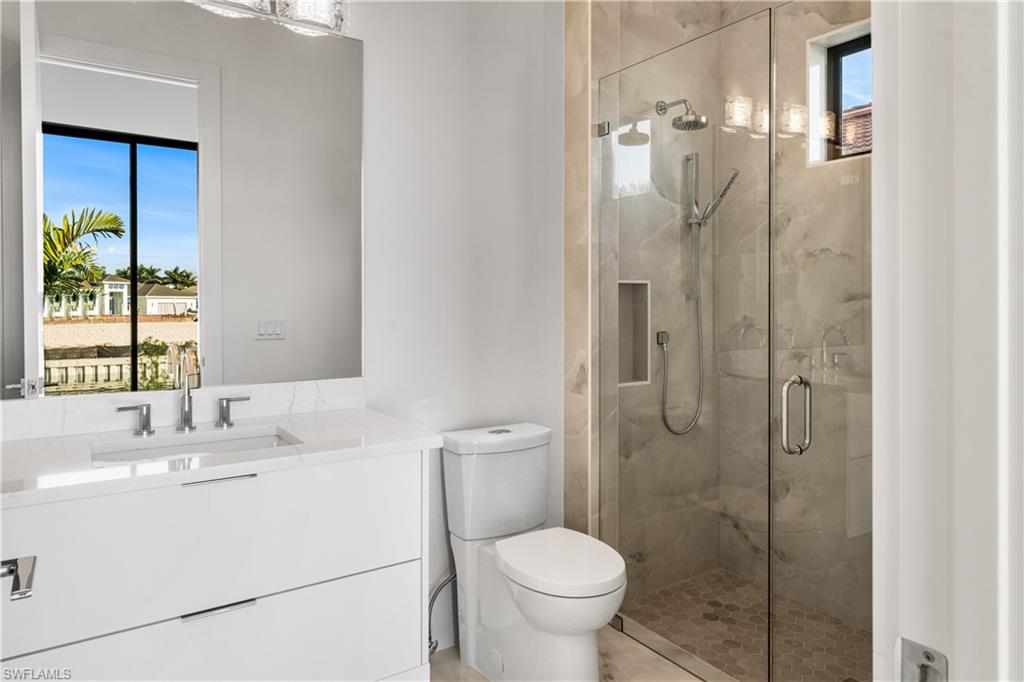 Full bath with vanity and a marble finish shower