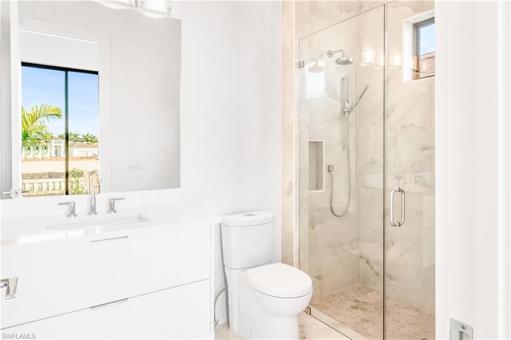 Full bathroom with vanity and a marble finish shower
