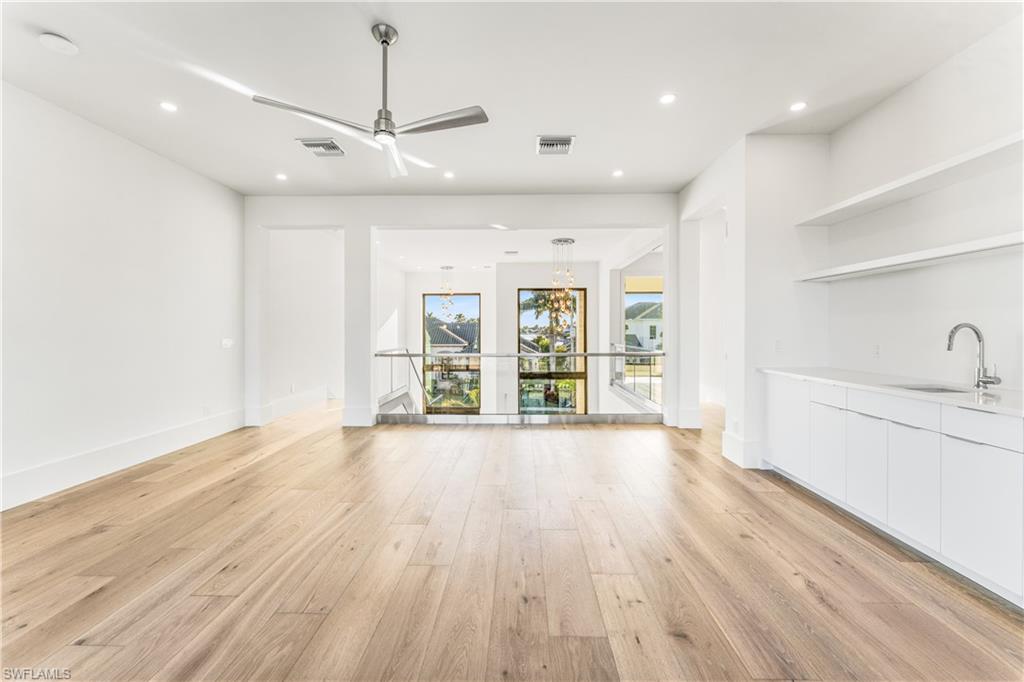 Unfurnished living room with a ceiling fan, light wood-style flooring, and recessed lighting