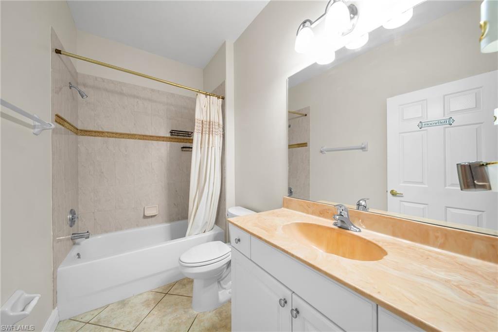 Full bathroom featuring shower / tub combo, vanity, and light tile patterned flooring