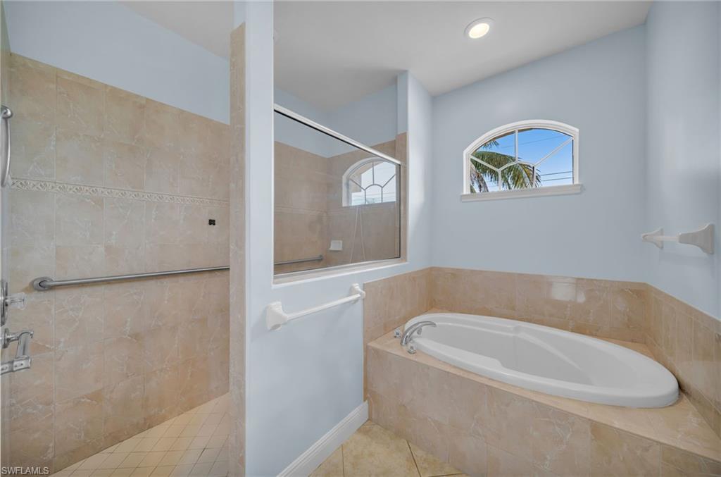 Full bathroom with walk in shower, a bath, and tile patterned flooring