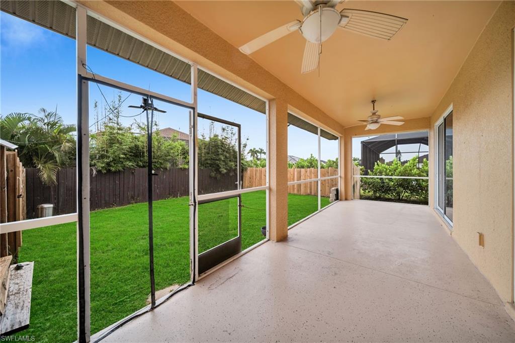 Unfurnished sunroom featuring a ceiling fan