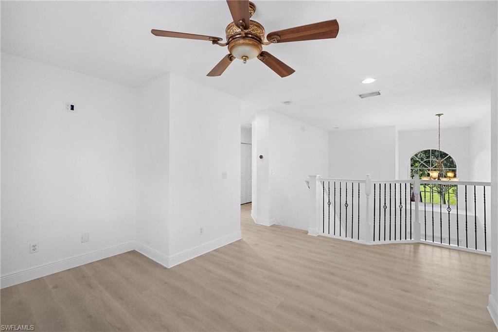 Stairs landing featuring recessed lighting, a chandelier, light wood-style floors, and a ceiling fan
