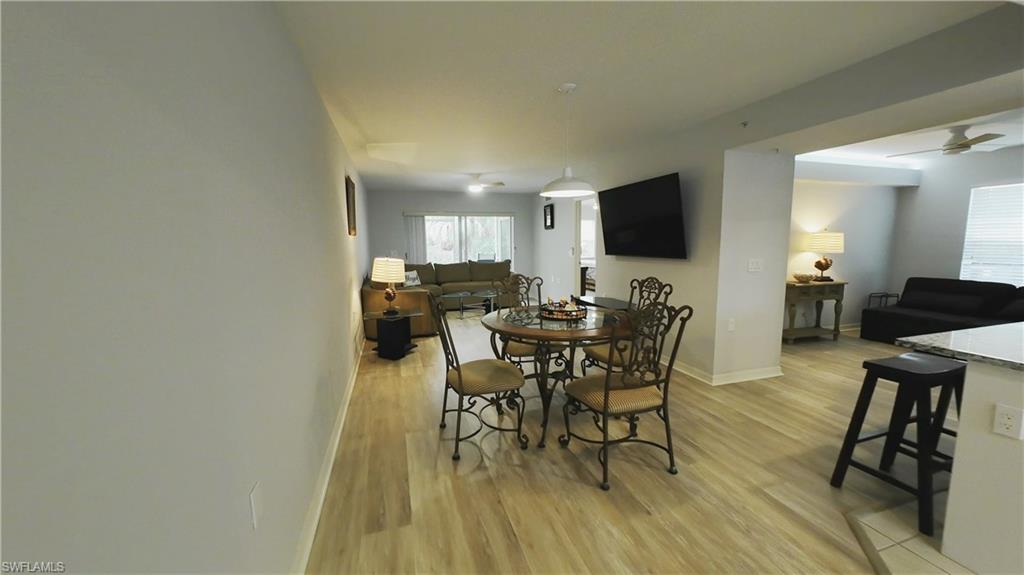 Spacious living area featuring wood-finish flooring, recessed lighting, and a neutral color palette