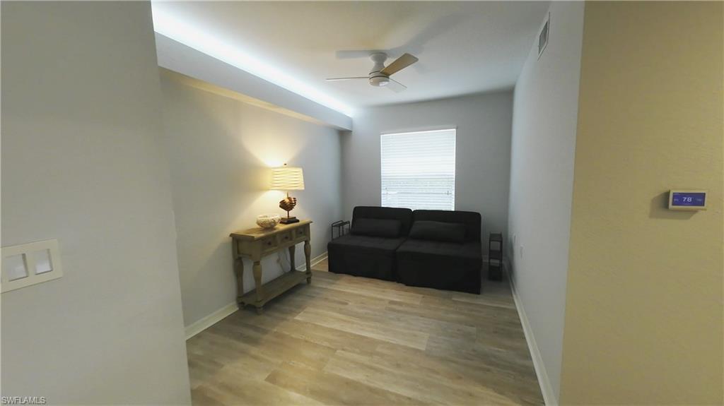 Room featuring wood-finish flooring, recessed ceiling lighting, a ceiling fan, and a window with horizontal blinds
