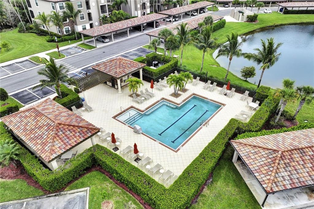 Aerial view of a pool and a nearby body of water