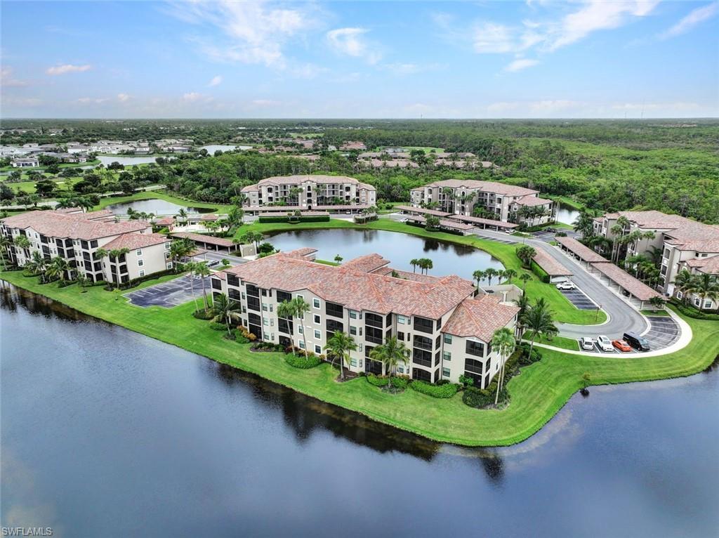 Drone / aerial view of apartment complex and a large body of water
