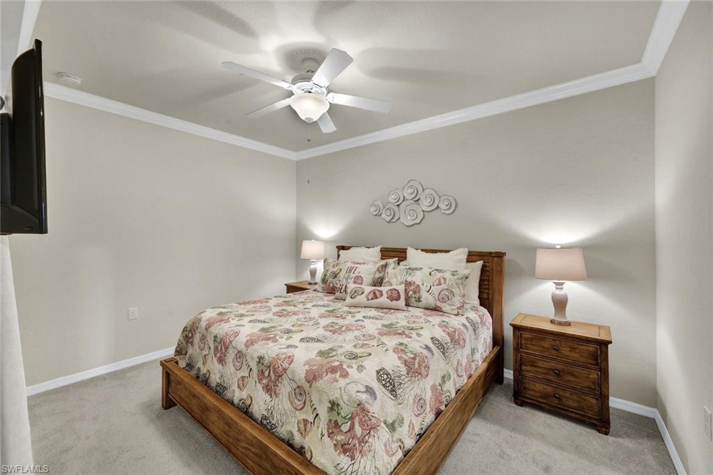 Bedroom featuring crown molding, ceiling fan, and light colored carpet