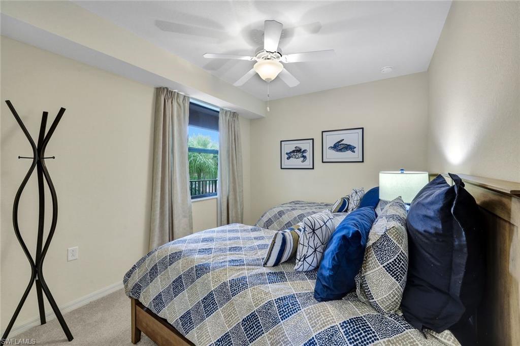 Bedroom with light colored carpet and ceiling fan