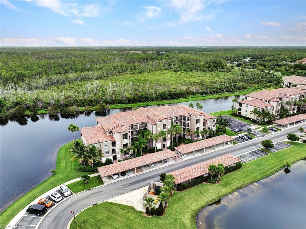 Aerial view of a heavily wooded area and a nearby body of water