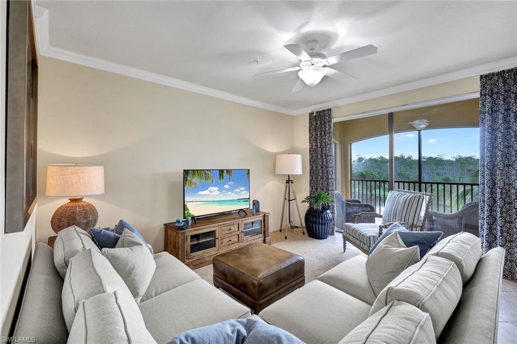 Living area with ornamental molding and ceiling fan