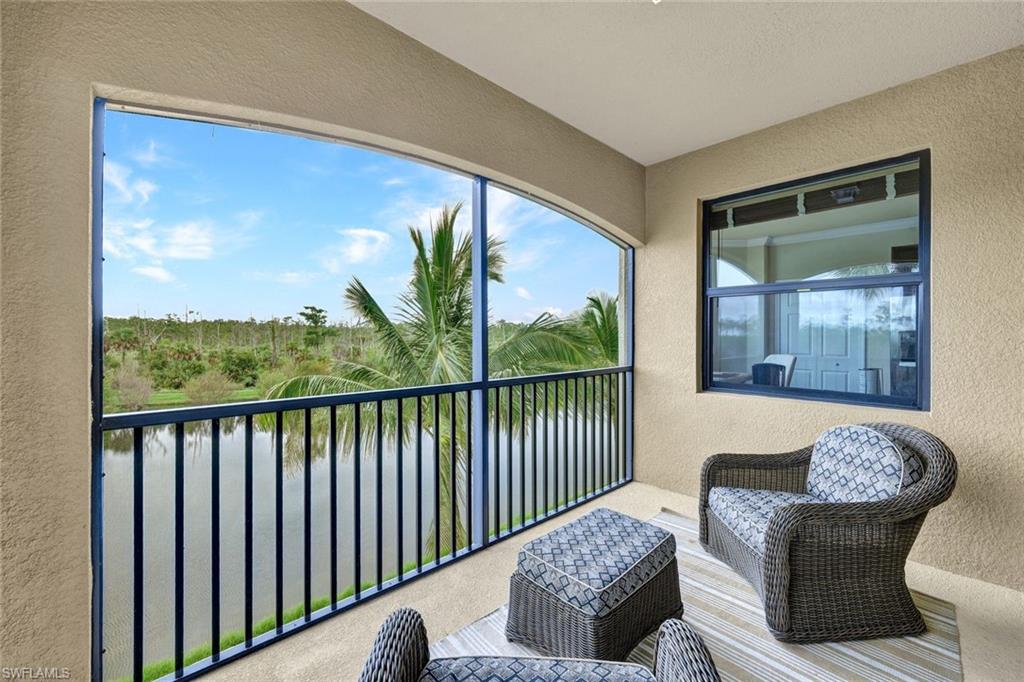 Balcony with a sunroom and a water view