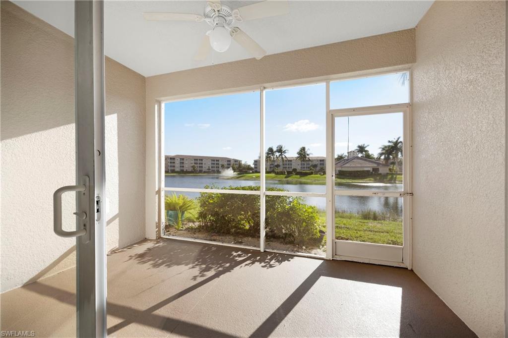 Unfurnished sunroom featuring a textured wall, healthy amount of natural light, and a water view