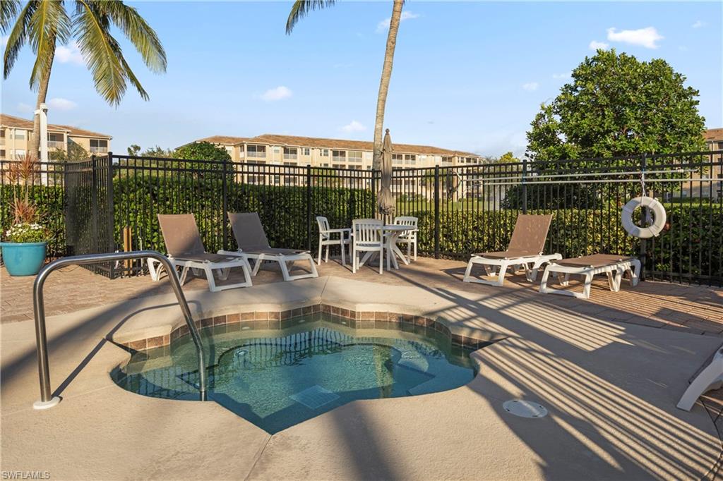 View of swimming pool with a community hot tub and a patio area