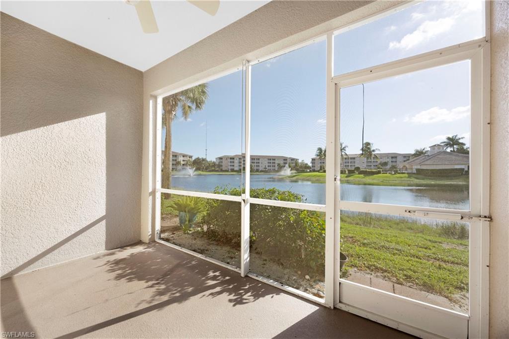 Unfurnished sunroom featuring a water view and a ceiling fan