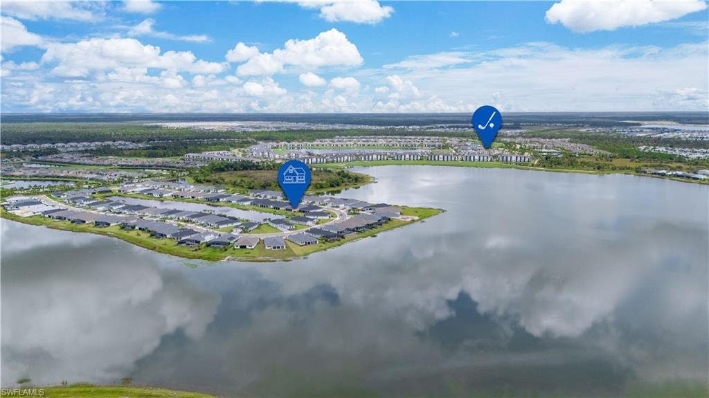 Aerial view of residential area featuring a large body of water