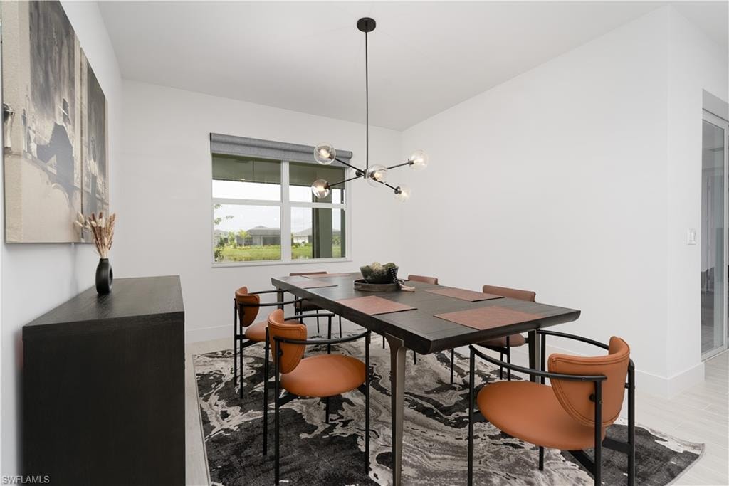 Dining room with a chandelier and baseboards