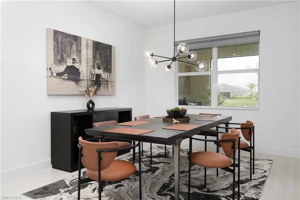 Dining area with a chandelier and light wood-type flooring