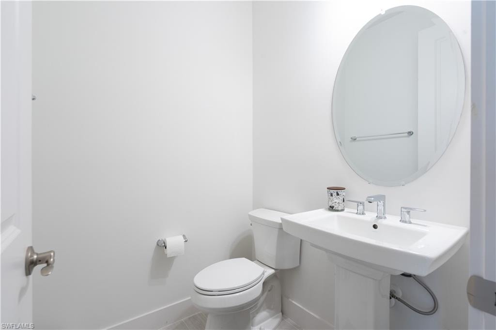 Bathroom with toilet and baseboards
