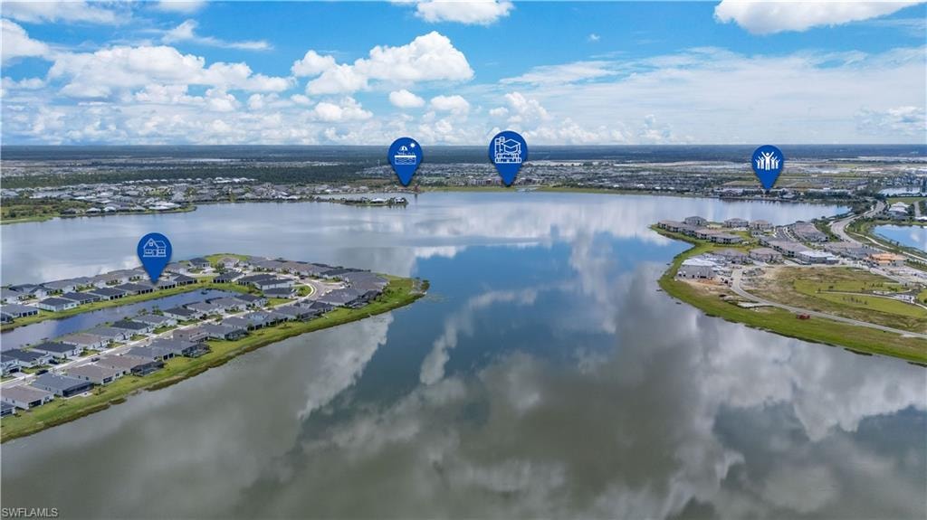 Aerial view of residential area featuring a nearby body of water