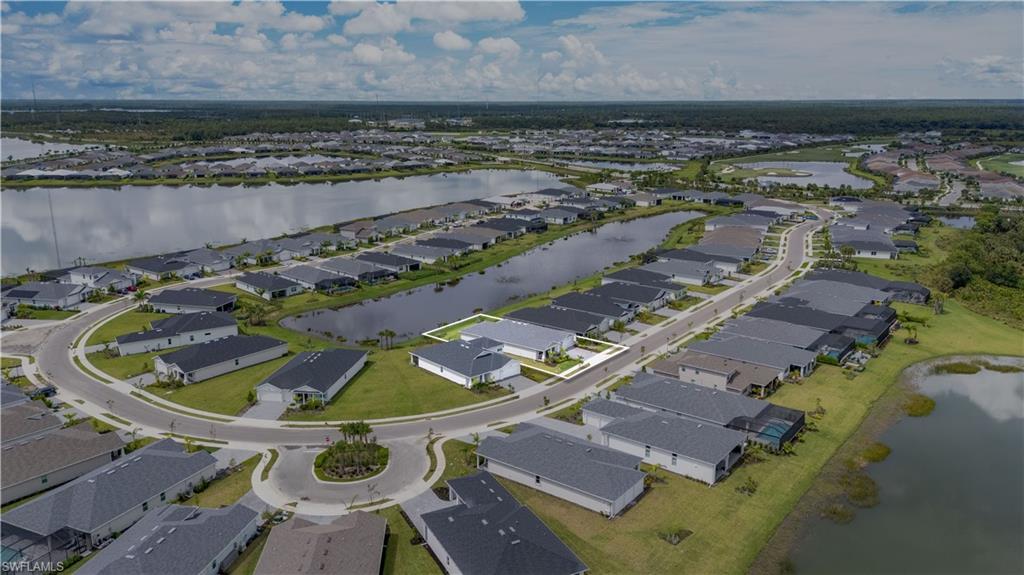 Aerial overview of property's location with a large body of water and nearby suburban area