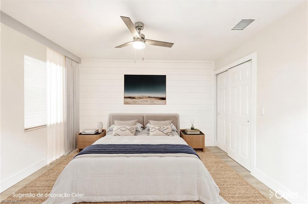Bedroom featuring wood finished floors, ceiling fan, a closet, and wooden walls