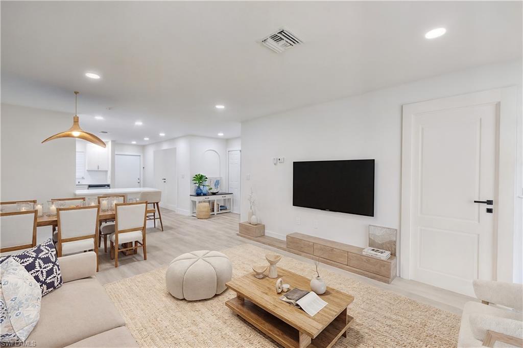 Living room with recessed lighting and light wood-style flooring