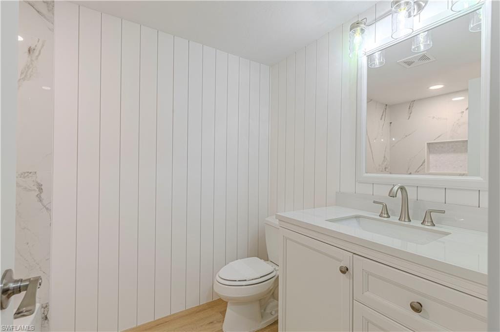 Full bathroom with vanity, light wood-style flooring, and recessed lighting