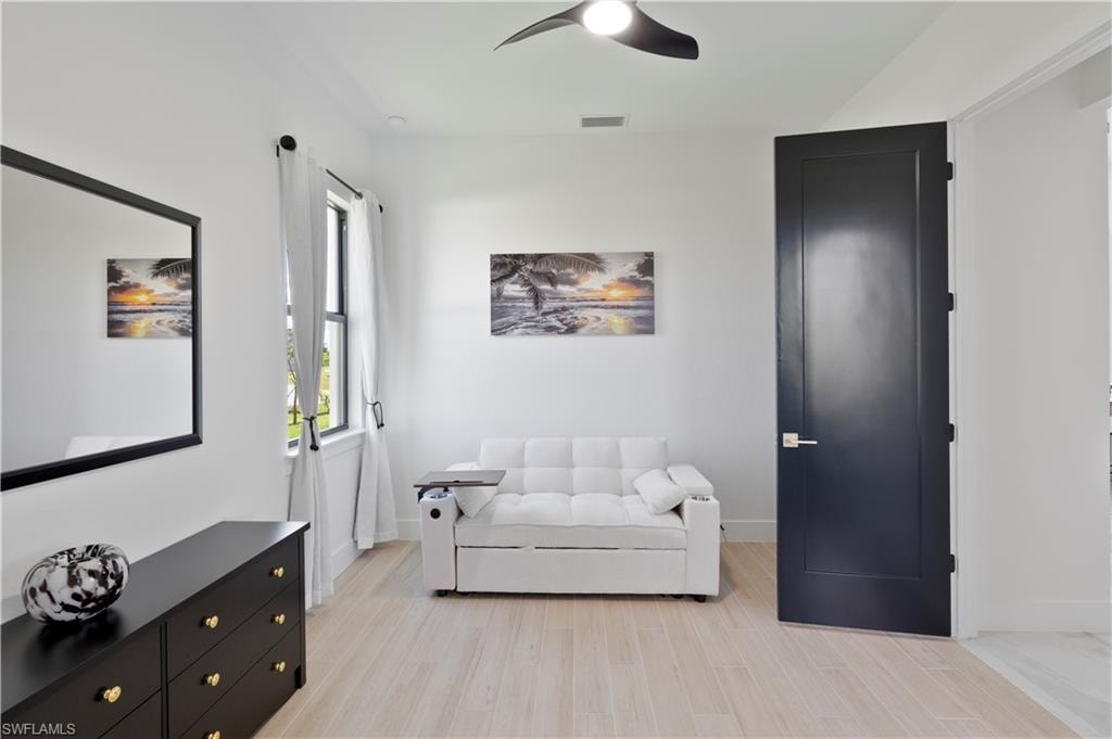 Living area featuring a ceiling fan and light wood finished floors