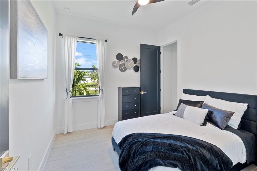 Bedroom with light wood-type flooring and a ceiling fan